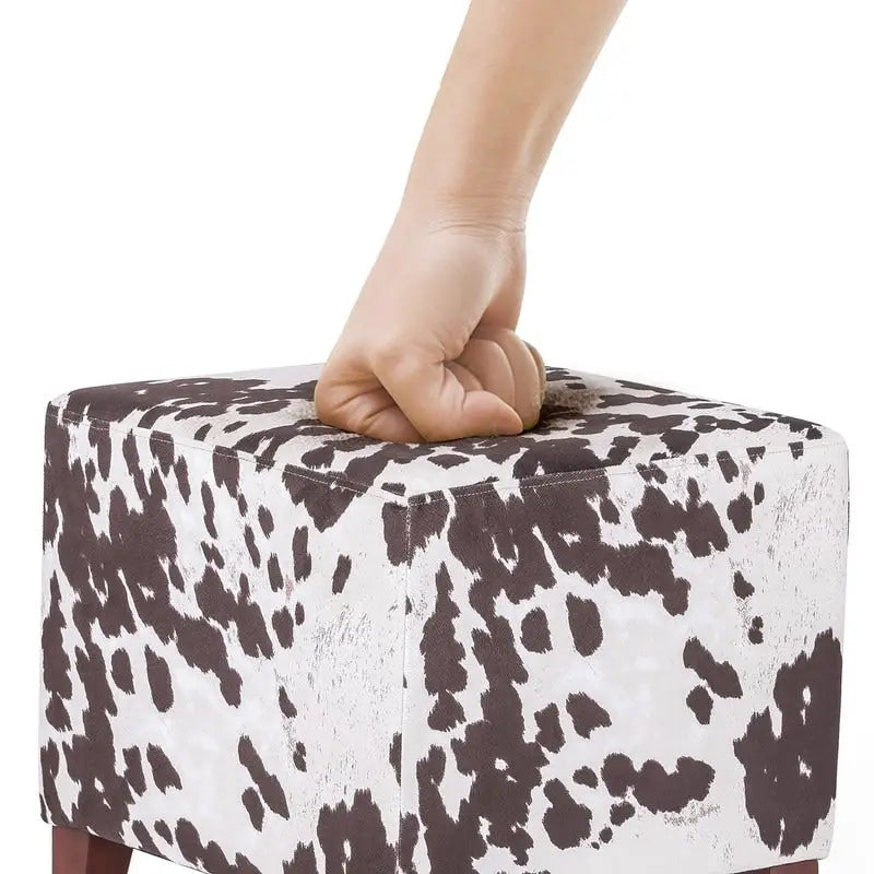 Pouf cube style britannique Adeco à motif vache, repose-pieds élégant